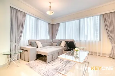 a living room with a couch and a table at Captivating Sky & Sea Views in Two Bedroom Suite in Dubai