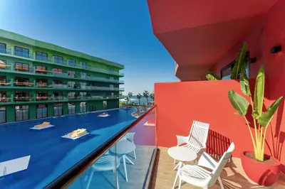 a balcony with chairs and a swimming pool at Voco Dubai Monaco, The Heart of Europe by IHG-Adult only in Dubai