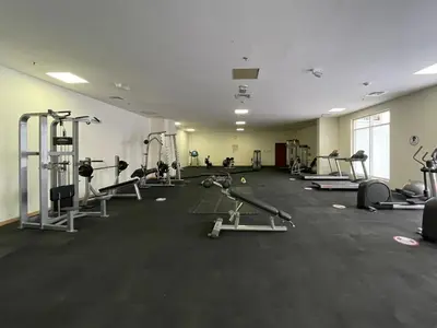 a gym with several treadms and machines in a room at The Smart Concierge - Plaza residence in Dubai