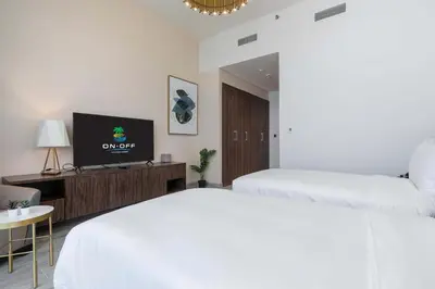 a hotel room with two beds and a flat screen tv at ON OFF HH-AVANI HOTEL-3BR -Full Palm View in Dubai