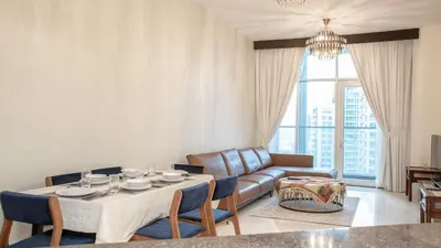 a living room with a table and a couch at AWS Holiday Homes - Luxury Living besides Canal in Dubai