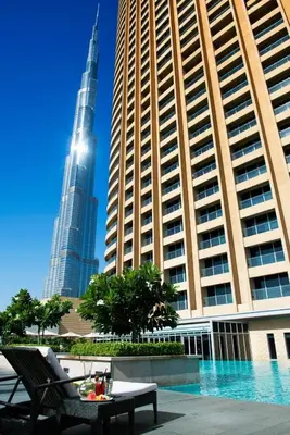 a view of the burj khalifa and a table in front of buildings at Emaar Residences in Dubai