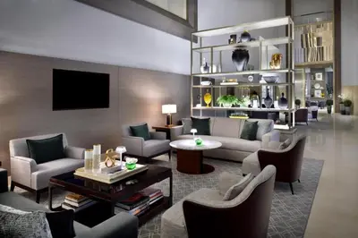 a living room with couches and chairs and a tv at Emaar Residences in Dubai