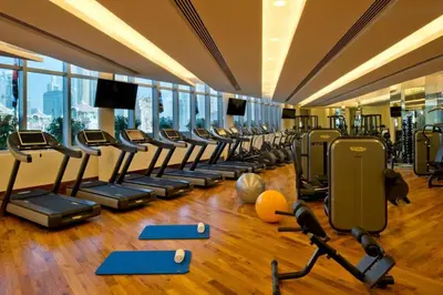 a gym with rows of treadmills and exercise equipment at Emaar Residences in Dubai
