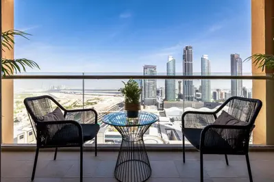 a balcony with a table and chairs and a view of a city at Emaar Residences in Dubai