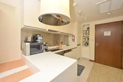 a kitchen with a white counter and a microwave at Emaar Fashion Avenue - Formerly Address Dubai Mall Residence in Dubai