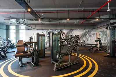 a gym with several treadmills and cardio machines at Frank Porter - Studio One in Dubai