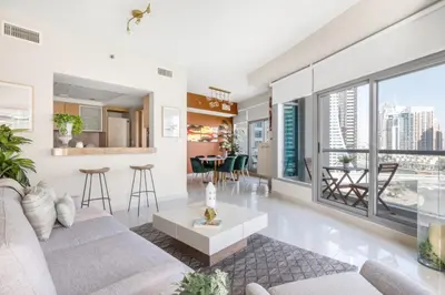 a living room with a couch and a table at GuestReady - Marina View | Fairfield Tower in Dubai