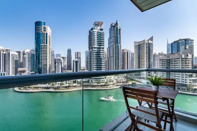 a balcony with a table and chairs and a view of a city at GuestReady - Marina View | Fairfield Tower in Dubai