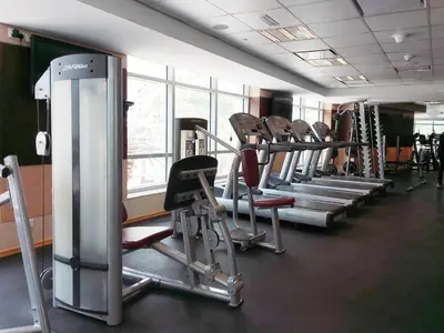 a gym with rows of tread machines in a row at GuestReady - Marina View | Fairfield Tower in Dubai