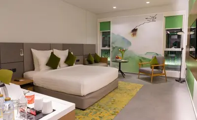 a bedroom with a bed and a table and a chair at Al Khoory Courtyard Hotel in Dubai