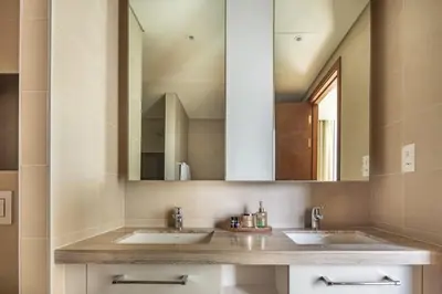a bathroom with two sinks and a large mirror at Frank Porter - BLVD Heights T1 in Dubai