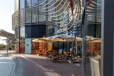 a building with tables and chairs in front of a building at Frank Porter - BLVD Heights T1 in Dubai