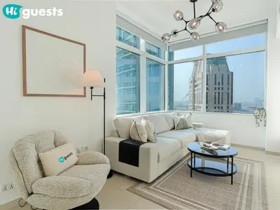 a living room with a couch and a chair at HiGuests - Exceptional Apt with Furnished Terrace By the Sea in Dubai