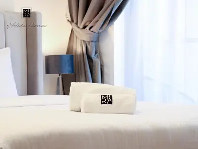 a bed with two towels on top of it at Mira Holiday Homes - Newly Furnished 1 bedroom in Creek Vista Tower B Sobha Hartland in Dubai