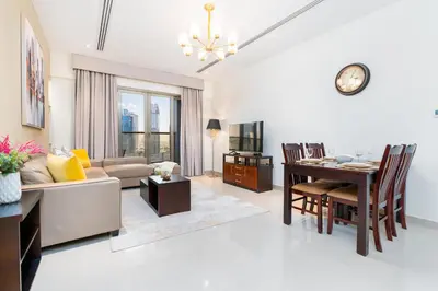 a living room with a couch and a table at White Sage - Elite Residence 1 bedroom in Dubai