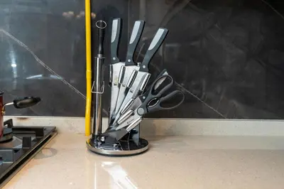 a group of knives in a holder on a counter at White Sage - Elite Residence 1 bedroom in Dubai