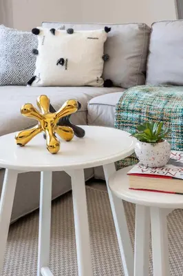 a living room with a white couch and two tables at Frank Porter - Executive Tower F in Dubai