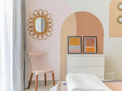 a mirror in a room with a chair and a table at Charming Tropical Apartment Minutes To Dubai Mall in Dubai