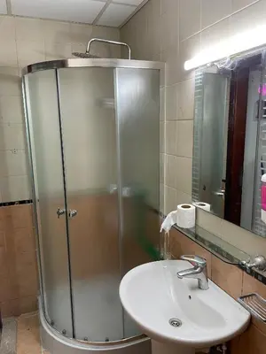 a bathroom with a shower and a sink at AlBarsha 1 Hostel by PHM in Dubai
