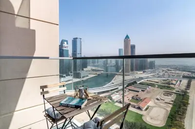a balcony with a bench and a view of the city at The Smart Concierge - Amna Tower in Dubai