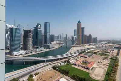 a view of a city with a river and skyscrapers at The Smart Concierge - Amna Tower in Dubai