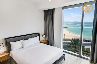 a bedroom with a bed and a view of the beach at Keysplease Fascinating SeaViews! 2 B/R Luxury Apt 52/42, Marina in Dubai