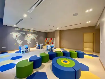 a room with blue and green chairs and a world map at Keysplease Fascinating SeaViews! 2 B/R Luxury Apt 52/42, Marina in Dubai