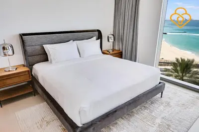 a bedroom with a bed with a view of the beach at Keysplease Fascinating SeaViews! 2 B/R Luxury Apt 52/42, Marina in Dubai