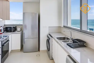 a kitchen with a stainless steel refrigerator and a sink at Keysplease Fascinating SeaViews! 2 B/R Luxury Apt 52/42, Marina in Dubai