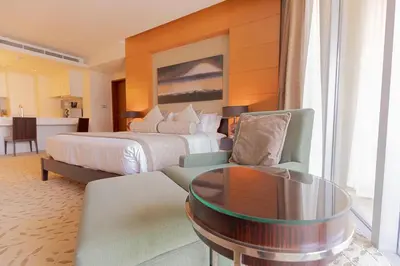 a hotel room with a bed and a coffee table at FAHH - Amazing Studio in Emaar Fashion Avenue in Dubai