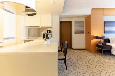 a kitchen with a counter and a dining room at FAHH - Amazing Studio in Emaar Fashion Avenue in Dubai
