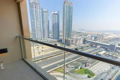 a view of a city from a balcony in a building at FAHH - Amazing Studio in Emaar Fashion Avenue in Dubai