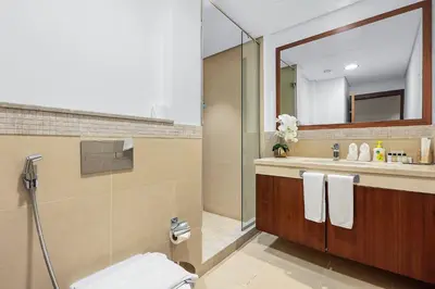 a bathroom with a shower and a toilet and a sink at FIRST CLASS 3BR with full BURJ KHALIFA and FOUNTAIN VIEW in Dubai