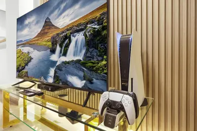 a video game controller in front of a tv at FIRST CLASS 3BR with full BURJ KHALIFA and FOUNTAIN VIEW in Dubai
