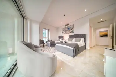 a living room with a bed and a couch and a room at The Marina PENTHOUSE near JBR 46th Floor in Dubai