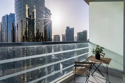 a balcony with a table and a view of a city at GuestReady - Jumeirah Skyline Apartment in Dubai