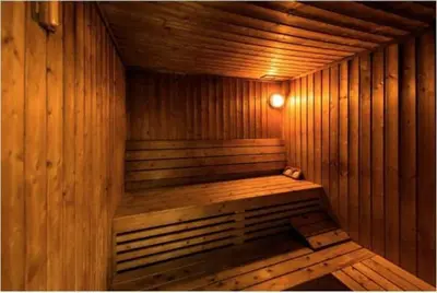 a wooden sauna with a wooden bench in it at GuestReady - Jumeirah Skyline Apartment in Dubai