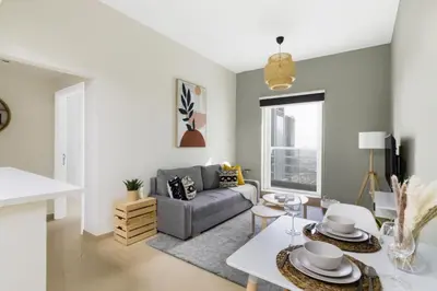 a living room with a couch and a table at GuestReady - Jumeirah Skyline Apartment in Dubai