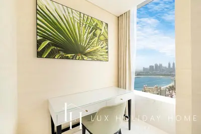 a desk in a room with a view of the ocean at LUX Iconic Views at The Palm Tower Suite 2 in Dubai