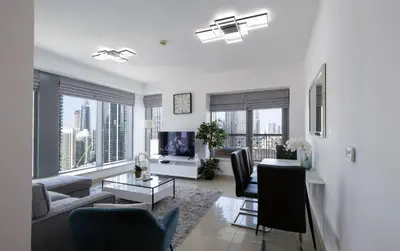 a living room with a couch and a table at Signature 2BR with Burj Khalifa & Fountain View in Dubai