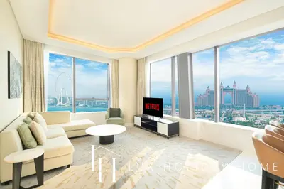a living room with a couch and a tv at LUX Iconic Views at The Palm Tower Suite 1 in Dubai