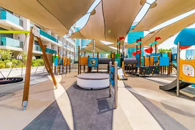 a playground with a slide and chairs in a building at Luxury MAG 318 Studio Near Dubai Mall in Dubai