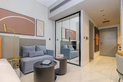 a living room with a couch and a table at Luxury MAG 318 Studio Near Dubai Mall in Dubai