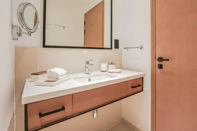 a bathroom with a sink and a mirror at Modern 2BR High Floor Haven in Vida Dubai Marina in Dubai