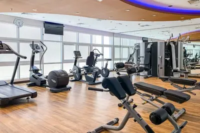 a gym with several treadmills and exercise bikes at Frank Porter - Siraj Tower in Dubai