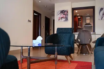 a living room with a table and two chairs and a table and a chair at Burj Khalifa view, birds chirping, cozy and stylish in Dubai
