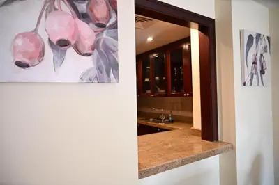 a bathroom with a mirror and a painting on the wall at Burj Khalifa view, birds chirping, cozy and stylish in Dubai