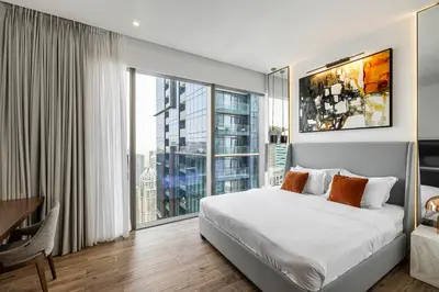 a bedroom with a large bed and a large window at 2BR Marina Gate 3 High Floor Marina View in Dubai