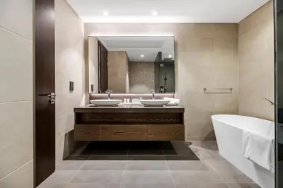 a bathroom with two sinks and a tub and a mirror at 2BR Marina Gate 3 High Floor Marina View in Dubai